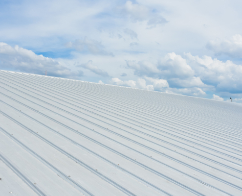 Metal sheet roofing on commercial construction with blue sky