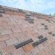 Roof with damaged shingles from storm