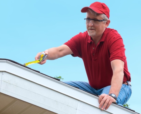 worker inspecting residential roof